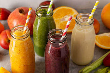 Closeup fruit smoothie bottles, healthy detox drinks.