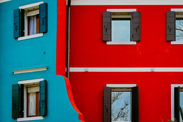 Blue and red colorful building with windows in Italy
