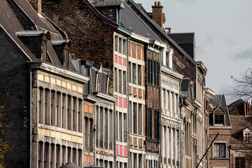 Medieval brick and stone facades in the city center of Liege, Belgium, belonging to residential urban buildings. . - obrazy, fototapety, plakaty