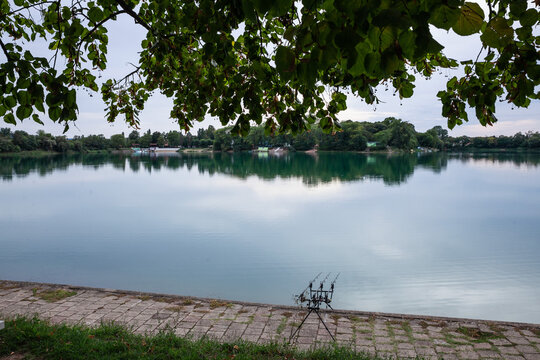 Panorama of bela crkva lakes at dusk with calm water, fishing rods and sunny sky. Also called Belocrkvanska jezera, they are serbian major touristic natural destination..
