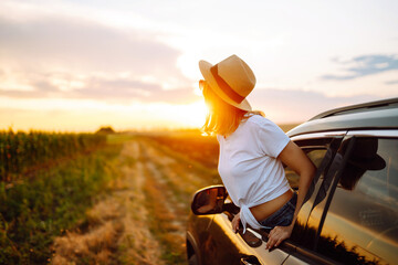 Towards adventure! Young woman is resting and enjoying the trip in the car. Lifestyle, travel, tourism, nature, active life.