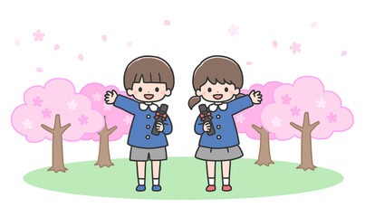 卒園式　桜の前に並んで立つ男の子と女の子
