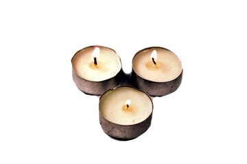 three white candles isolated without background