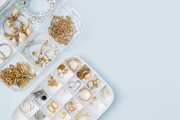 White jewelry box with trendy bijouterie . Chains, necklace, earrings and bracelets in jewelry case. Storage system for women's jewelry. Fashion accessories.