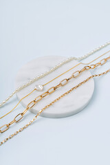Trendy jewelry with chains and pearl necklace. Stylish golden bijouterie. Fashion accessories.