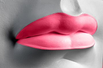 Close-up of a Lip in Viva magenta. Plaster elements in a modern style. Creative figurine made of plaster.