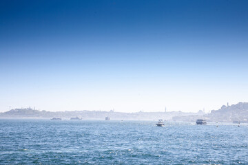 Selective blur on boats, yachts, ferries and shipsin Istanbul, touring the Bosphorus straight and the marmara sea in summer with a panorama over the European side of the city of Istanbul, Turkey..