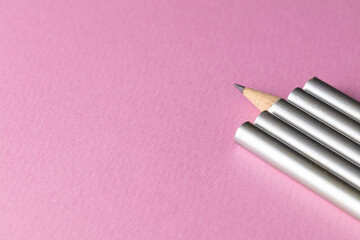 Group of silver pencils with pink vibrant background. Standout and be different from others...