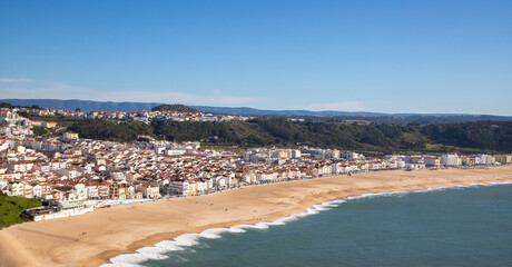 Fototapeta na wymiar Landscape of the empty beach in Nazare - Portugal