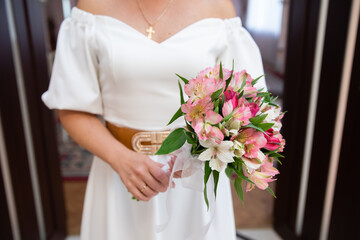 Bride's bouquet in the hands of the bride