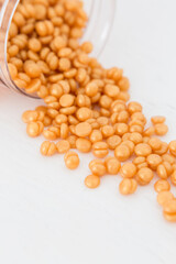 Beautiful golden depilatory wax granules, macro, close up