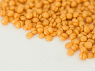 Beautiful golden depilatory wax granules, macro, close up, texture