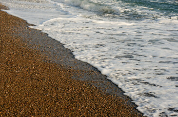 blue sea foaming wave sandy shore