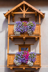 Traditional alpine wooden balconies decorated with flowers in Livigno, Sondrio, Italy