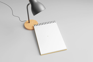 Realistic notebook or notepad with lamp for mockup isolated on white background. 3d rendering