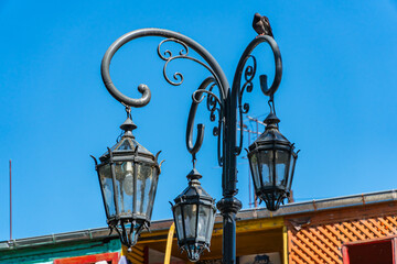 Fototapeta na wymiar Old street lamp on the background of the blue sky in the city of Buenos Aires, Argentina