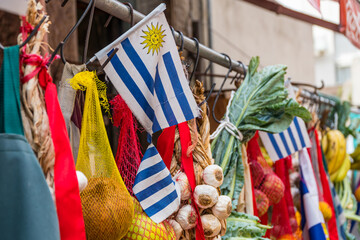 Fruit stall at street market in the old center of Montevideo Contents fruits and vegetables, onions, peppers and the flag of Uruguay