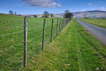 Fototapeta na wymiar Landscape at Halton East and a moorland road stretches into the distance. North Yorkshire