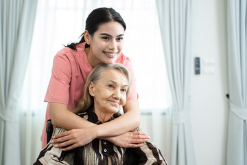 Medical care for the senior at home concept,Friendly nurse taking care elderly woman patient careful,give support empathy.