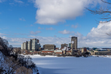Having a walk in the Majors Hill Park in downtown Ottawa Canada with view to historical buildings at a cold but sunny day in winter.