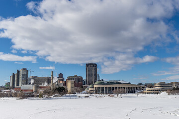 Fototapeta premium Having a walk in the Majors Hill Park in downtown Ottawa Canada with view to historical buildings at a cold but sunny day in winter.