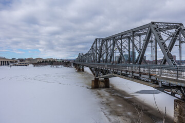 Having a walk in the Majors Hill Park in downtown Ottawa Canada with view to the historical Alexandra bridge at a cold but sunny day in winter.