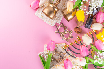 Passover, Pesah background. jewish Easter Passover spring holiday celebration, with accessories - menorah, matzo, spring flowers, wine bottle, gold wine glass, jewish david stars, copy space top view 
