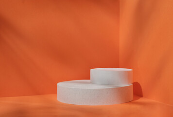 Minimal stage for a modern product display on a white podium cilinre on an orange background. High quality photo