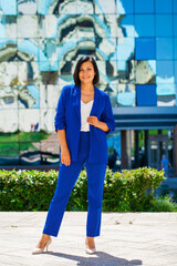 Happy beautiful brunette woman in blue suit