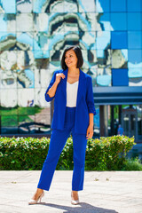 Happy beautiful brunette woman in blue suit