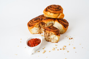 Salty bread with walnut poppy sesame and chili tomato sauce isolated on white background. The bread is called lokum locally in turkey.