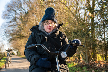 40 year old happy white woman with the Down Syndrome, wearing a hat and a winter jacket, Tienen, Belgium