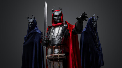 Naklejka premium Portrait of two members of esoteric cult and their leader holding sword.