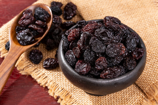 Healthy Food - Nuts Dehydrated Grapes; Photo On Wooden Background