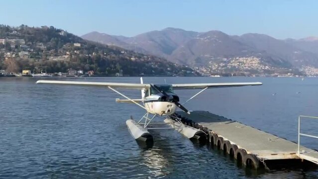 A water plane on a lake, with a beautiful landscape of mountains in the background. 