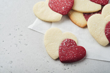 Valentines day cookies. Shortbread cookies inside sweet red heart with chocolate glaze on pink plate on grey background. Mothers day. Womans day. Sweet holidays baking. Valentines day card. Top view.