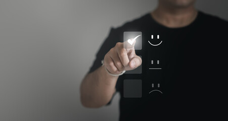 Concept of satisfaction and customer service. : Business man use his finger to touching the virtual screen the smiley happy face to show satisfaction with the service or give rating very impressive. 