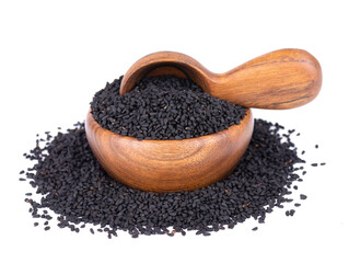 Black cumin seeds in wooden bowl and spoon, isolated on white background. Heap of black nigella seeds. Nigella sativa.
