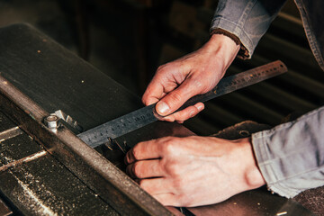 Work on woodworking machines and saws in a furniture workshop