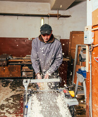 Work on woodworking machines and saws in a furniture workshop