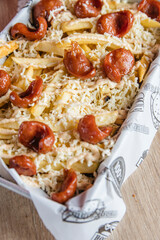 fries with sausage and many sauces