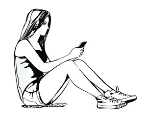 Young girl sits with a phone in her hands