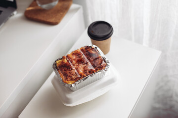 A take away box with lasagna, a concept of fast lunch at work 