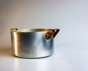 An old aluminum pan made in circa 1960 against a white background.