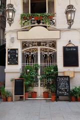 Entrance of a Characteristic Restaurant with the Menu displayed on Blackboards on the Exterior