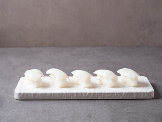 Squid sushi on stone plate