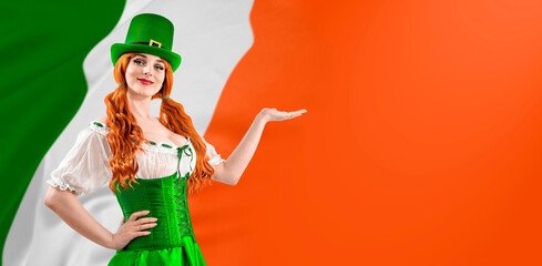 Young red-haired woman in a green Leprechaun elf costume during a St. Patrick's Day party. Happy Irish girl showing thumb up. Ireland National Independence Day March 17th