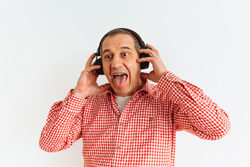 Middle-aged Caucasian man sticks out his tongue while enjoying music