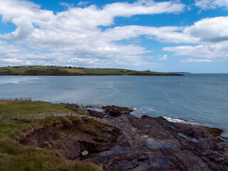 Clonakilty Bay under a cloudy sky on a summer day. Irish seascape, body of water under blue sky.