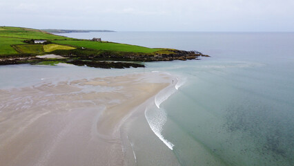 Fototapeta na wymiar The sea coast of Ireland on a cloudy summer day, top view. White sea waves on shore